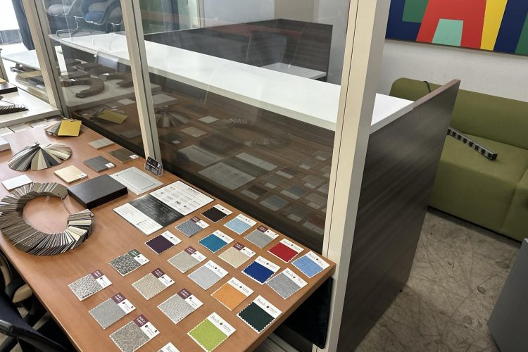 Interior design sample with various flooring options displayed on a table.