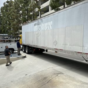 Large semi-truck with a white trailer for global shipping services.