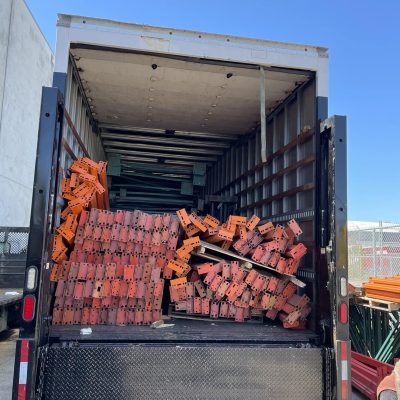 Shipping container loaded with red and orange bricks for nationwide delivery.