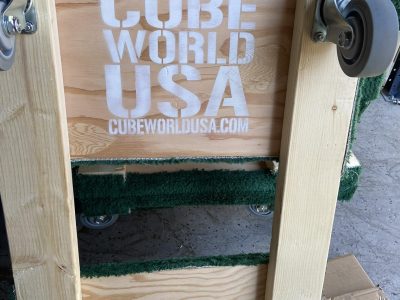 Moving cart with Cube World USA logo for facility relocation.
