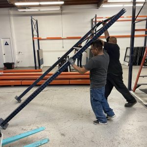 Installation of Cube World USA shelving units in a warehouse setting.