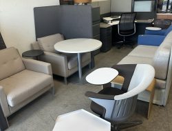 Modern office furniture setup with chairs, desks, and tables at Cube World USA.