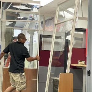 Office glass partition installation during facility move at Cube World USA.