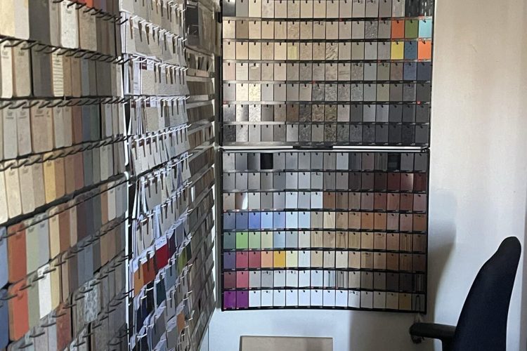 Color sample display for floor plan and design options at Cube World USA.