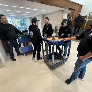 Professional installation team setting up equipment indoors.