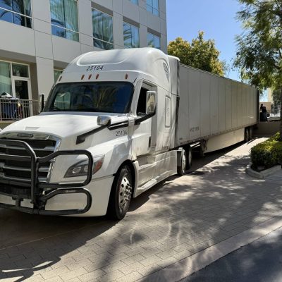 Large white freight truck delivering nationwide and international shipments.