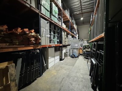 Warehouse with office furniture storage and organization shelves.