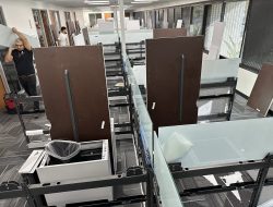 Office cubicles and desks being assembled during facility move.