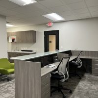 Office reception area with desks, chairs, and a waiting space.