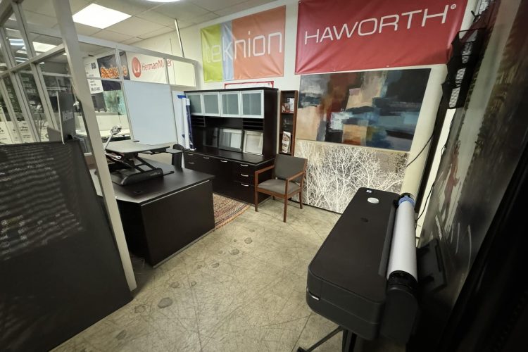 Office furniture display with desks, cabinets, and decor at Cube World USA.