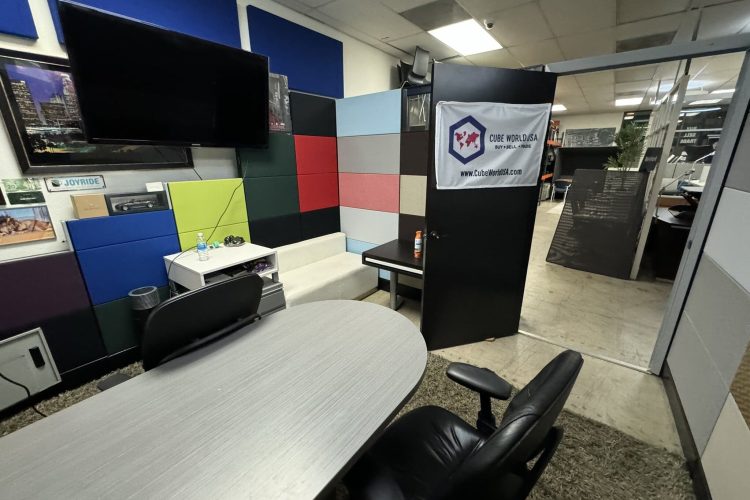 Office interior with Cube World USA branding and modern design elements.