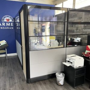 Office cubicle with glass walls for workspace separation during facility move.