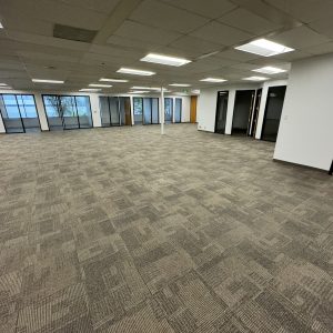 Office space interior with large windows and open layout for corporate moves.
