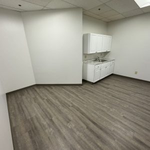 Empty office room with kitchenette, ideal for relocation or decommissioning projects.