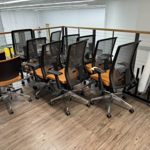 Office furniture moving and setup during facility decommissioning process.