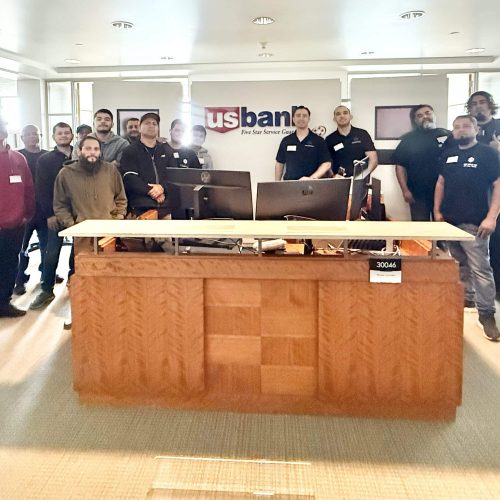 Group photo of Cube World USA team at a commercial brokers event in a modern office setting.