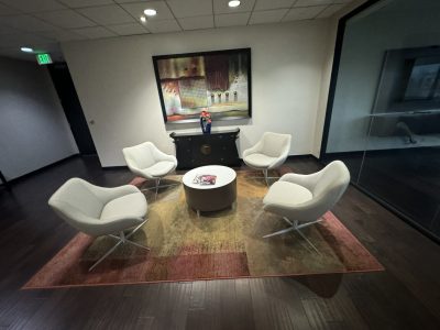 Office furniture liquidation: stylish lounge chairs and table setup for professional spaces.