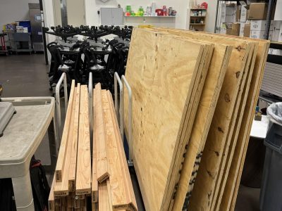 Office furniture and wood panels for sale at Cube World USA liquidation event.