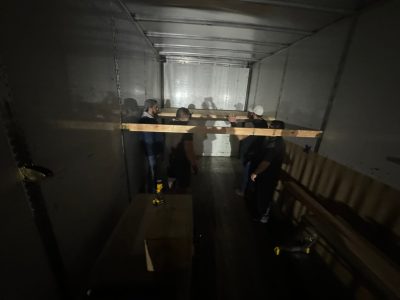 Liquidation of office furniture inside a moving truck at Cube World USA.