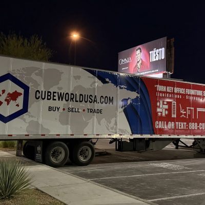 Large Cube World USA delivery truck parked at night.