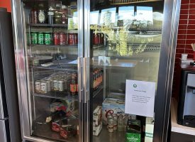 Commercial glass door refrigerator for beverages and snacks.