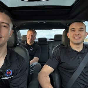 Professional installation team inside vehicle for Cube World USA services.