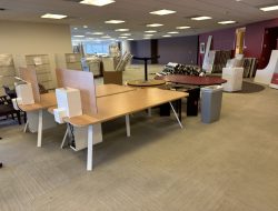 Office furniture and cubicles arranged for facility relocation at Cube World USA.