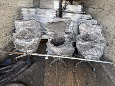 Office furniture packed in a truck for delivery or storage.