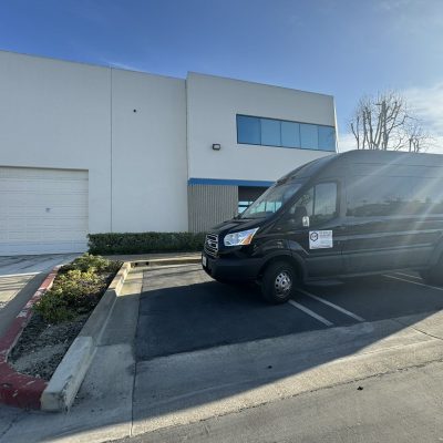 Delivery van for Cube World USA parked outside warehouse.