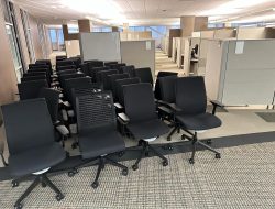 Modern office chairs arranged in a workspace during facility move.