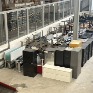 Office furniture and equipment being moved during facility decommissioning.