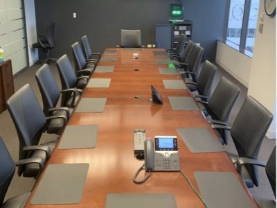 Office furniture liquidation: modern conference table with chairs in a professional meeting room set.