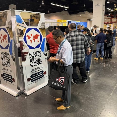 Attendees exploring Cube World USA's innovative equipment at a trade show.
