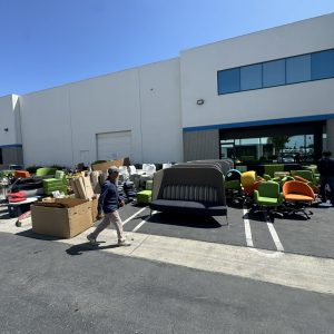 Office furniture and equipment being moved during facility decommission at Cube World USA.