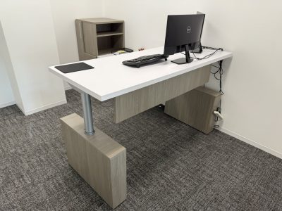 Office desk with computer, keyboard, and mouse for professional workspace.