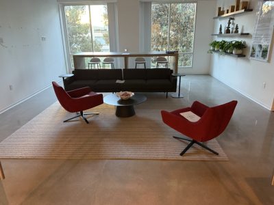 Stylish office lounge with modern seating and large windows for natural light.