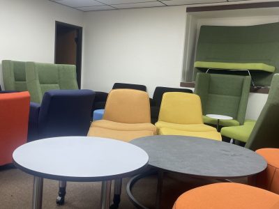 Contemporary lounge chairs and tables in vibrant colors for versatile seating options.