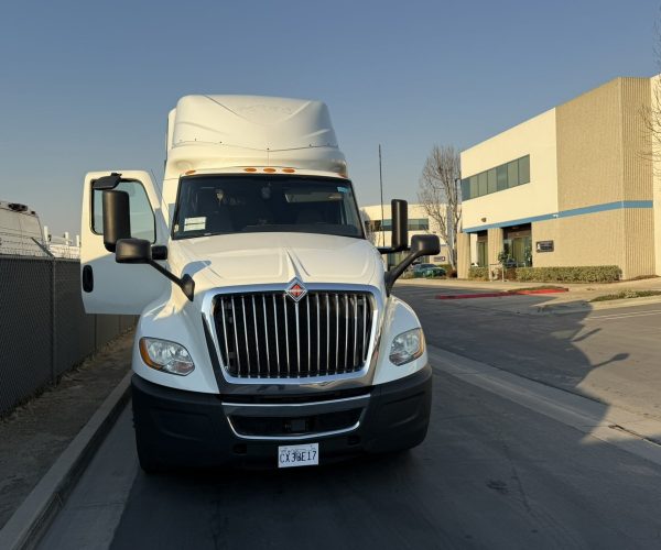 Commercial delivery truck parked outside Cube World USA facility.