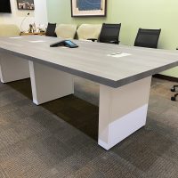 Modern conference table with black chairs in a professional office setting.