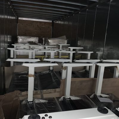 Shipping containers inside a truck for nationwide and international delivery.