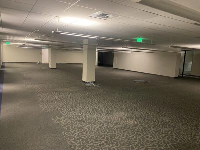 Office furniture liquidation in a large, empty commercial space. Perfect for office setup or renovat.
