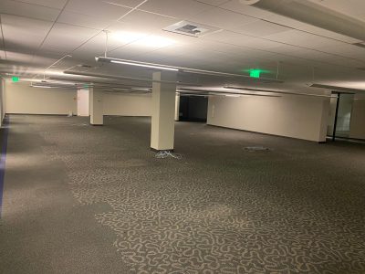 Office furniture liquidation in a large, empty commercial space. Perfect for office setup or renovat.