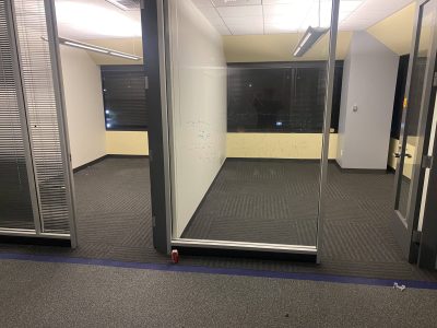 Office furniture liquidation sale with glass-walled conference rooms.