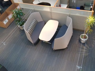Modern office meeting space with stylish seating and plants.