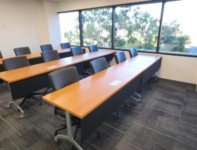 Classroom office furniture with desks and chairs in a bright, modern room.