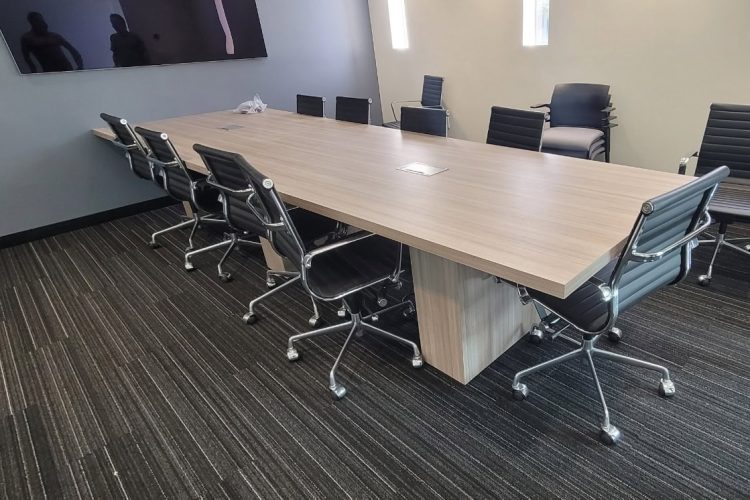 Professional conference room with large table and ergonomic chairs for meetings and presentations.
