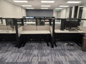 Office workspace with cubicles and computers at Cube World USA.
