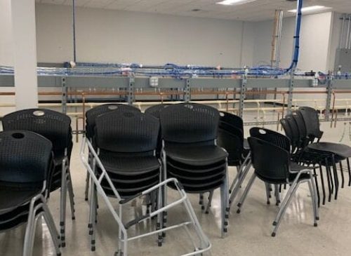 Accessible seating with mobility aid in a modern, well-lit conference room.