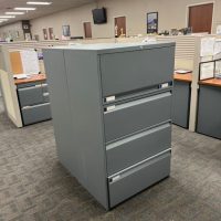 Gray office filing cabinet in cubicle workspace at Cube World USA.