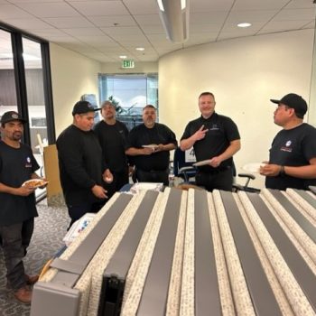 Office furniture liquidation sale with team members discussing options and arrangements.